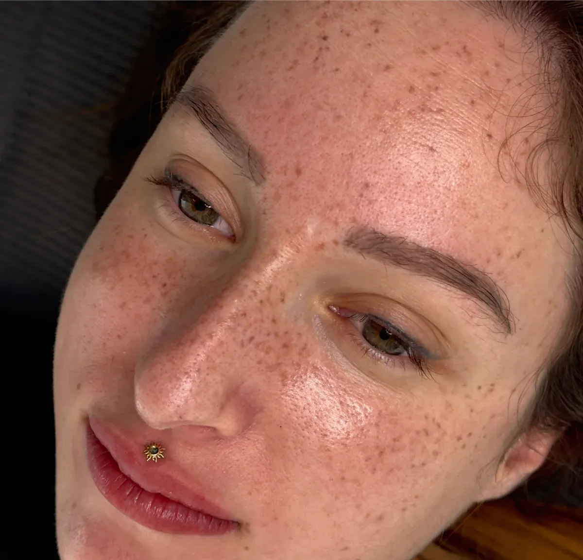 A client with a size L freckle tattoo