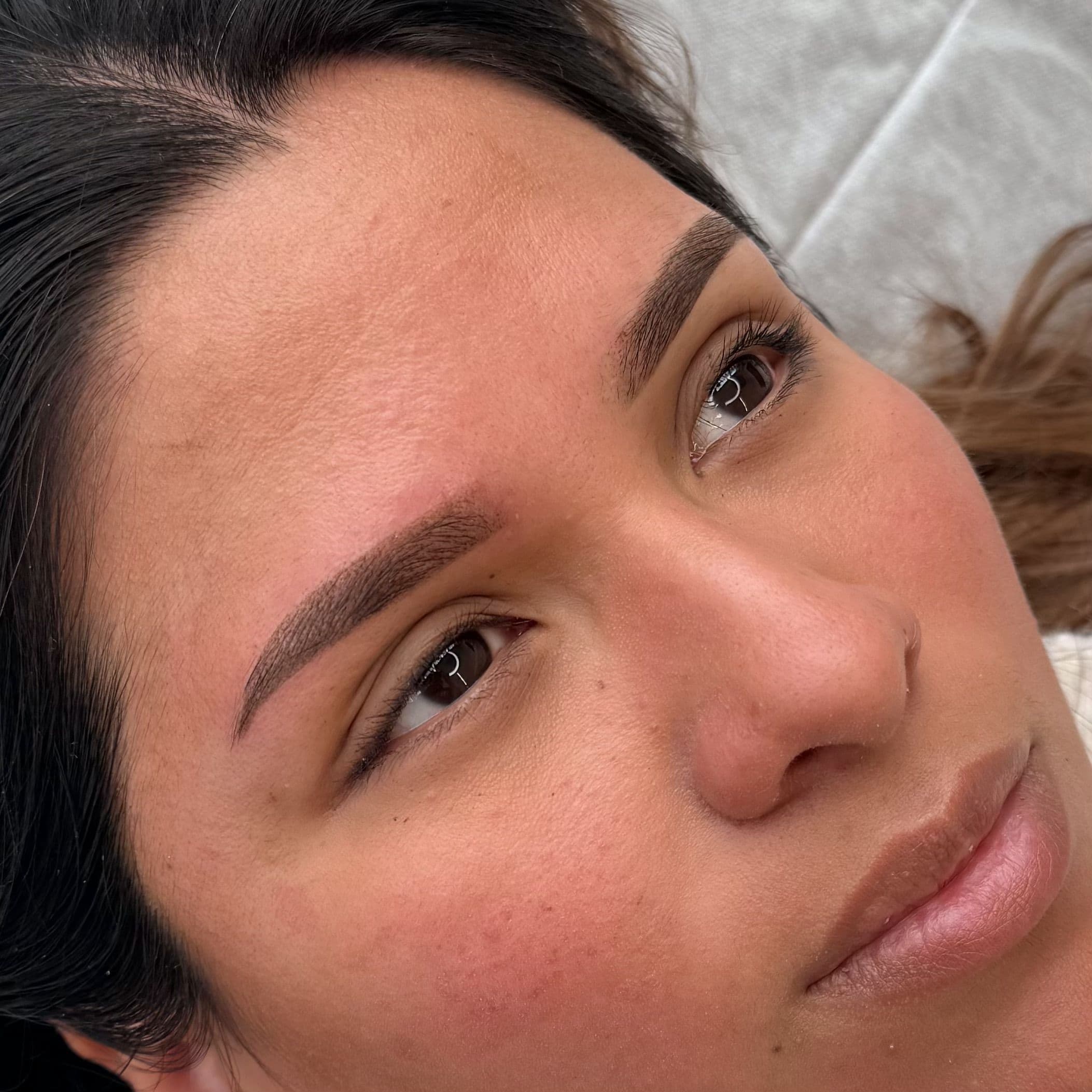 Tatouage des sourcils permanent technique microshading marron foncé sur peau mate, restructuration complète avec un fini poudré intense réalisé par Habiba Med.