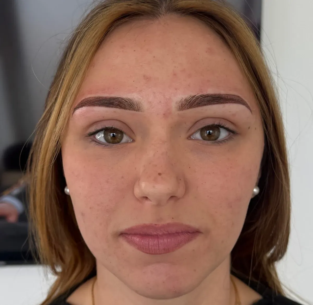 Brown-haired client right after powder brows